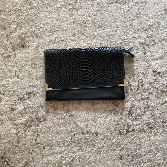 It’s a H and M bag black leather with gold points at the end and it’s spacious - Picture 1 of 7